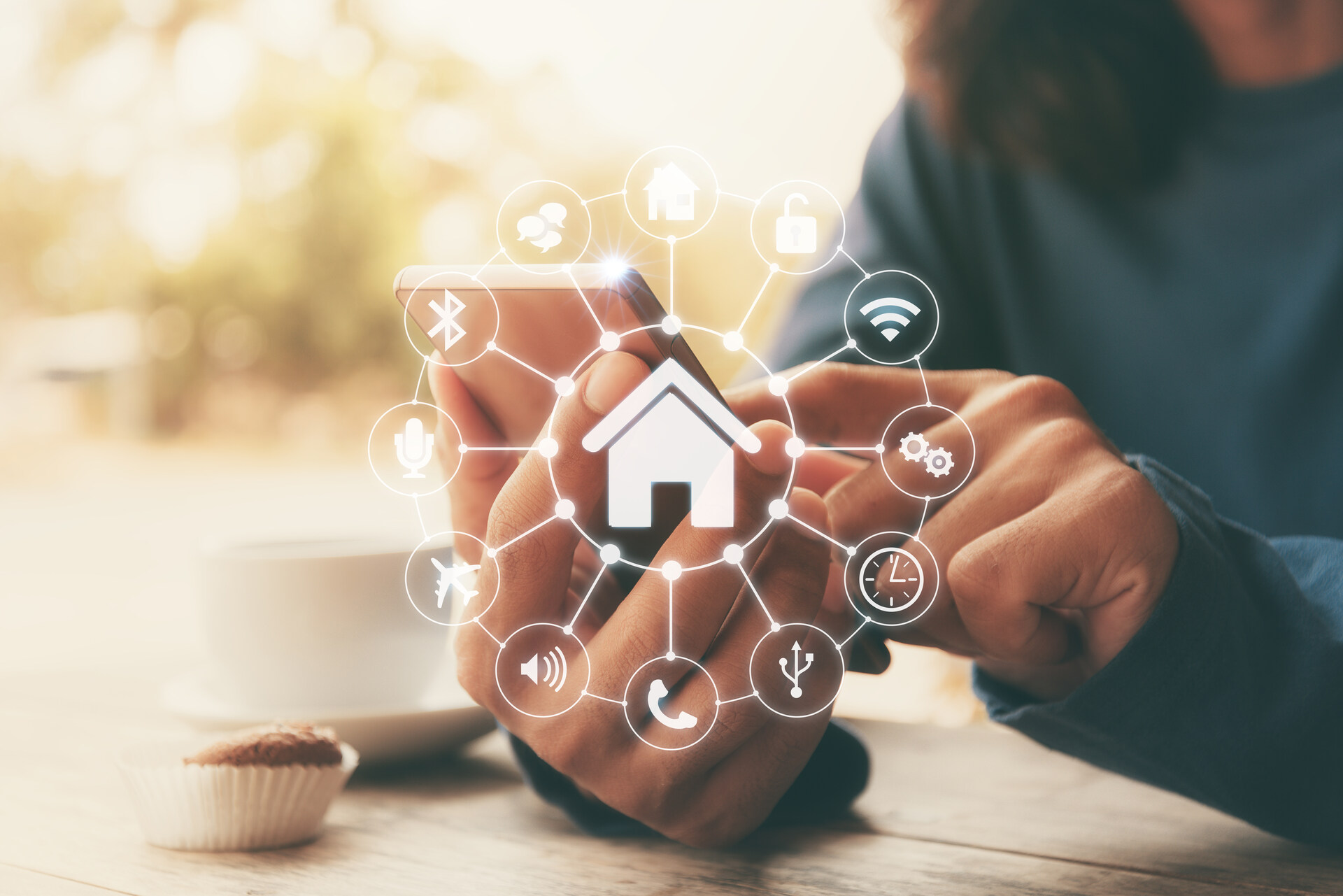 Person typing on their phone, controlling their smart home system